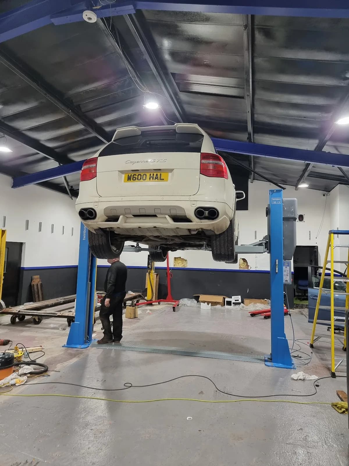 A MechTronic mechanic working on a car raised on the workshop ramp in Kilmarnock
